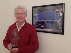 Secure Futures CEO Anthony Smith Holds the 2014 Solar Innovation Award 