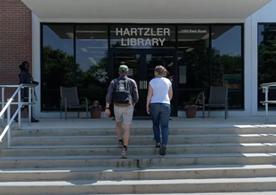 Students walk up the stairs to the Hartzler Library on the Eastern Mennonite University campus.