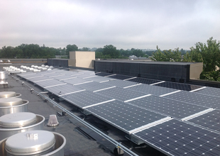A photo from the rooftop of an apartment building in Harrisonburg, Virginia, shows a solar panel array.