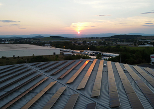 Sunset reflects in rooftop solar panels at InterChange Group's Black Ice cold storage facility.