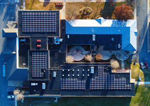 An aerial photo from directly overhead shows solar panels installed on the roof of a Lexington, Virginia, public school building.