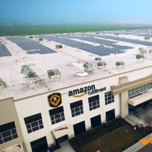 Rooftop solar panels are pictured on top of an Amazon fulfillment center.
