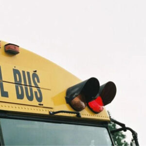 A detailed photo shows lights on top of a yelllow school bus.