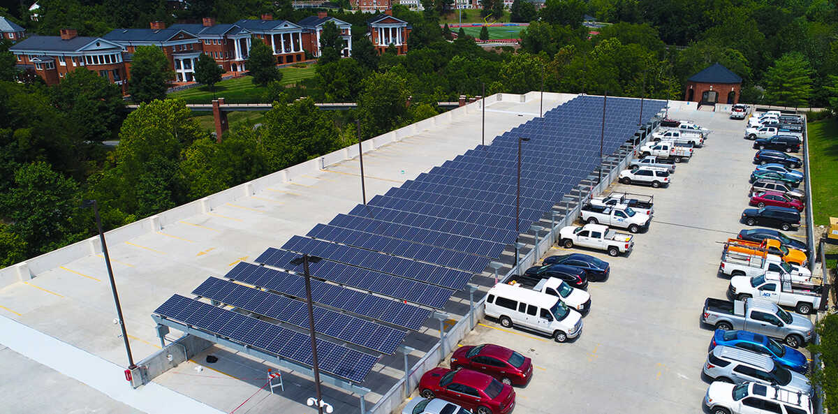 Aerial view of a parking lot shaded by solar panels.