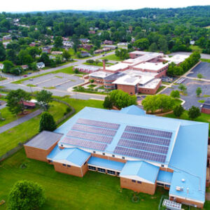 An aerial photo shows solar panels on the roofs of multiple public school buildings in Orange County, Virginia.